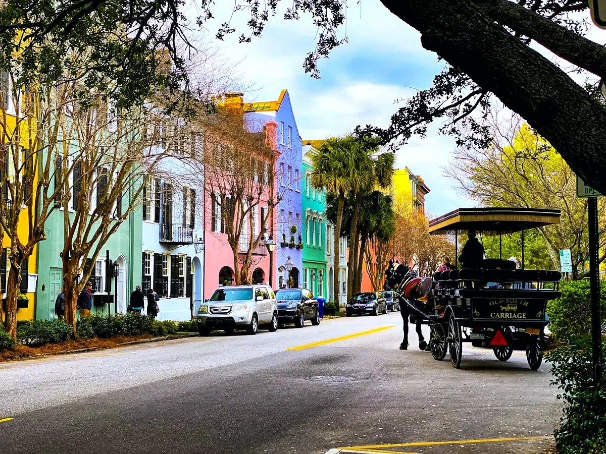 Rainbow Row houses on East Bay Street in Charleston with a carriage tour