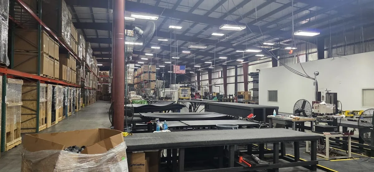 Aquonyx production floor with assembly tables and an American flag